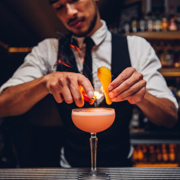 A bartender crafting a cocktail.