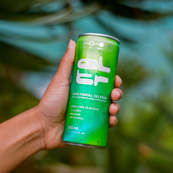 A hand holding a can of ALTR Seltzer
