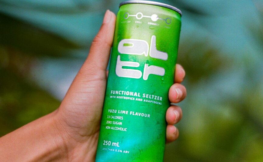 A hand holding a can of ALTR Seltzer