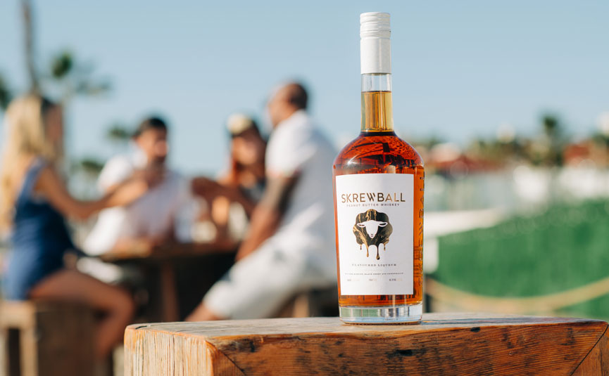 A bottle of Skewball Whiskey in an outside bar setting