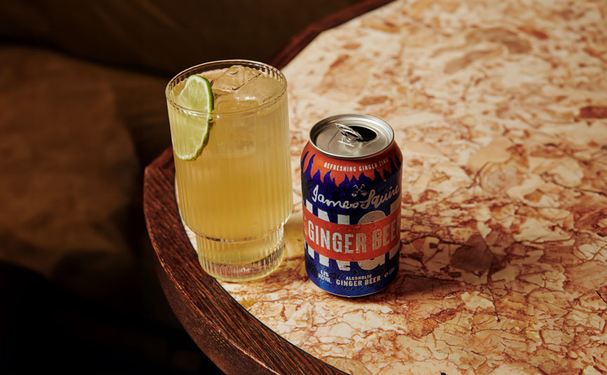 James Squire Ginger Beer can on a table beside a cocktail