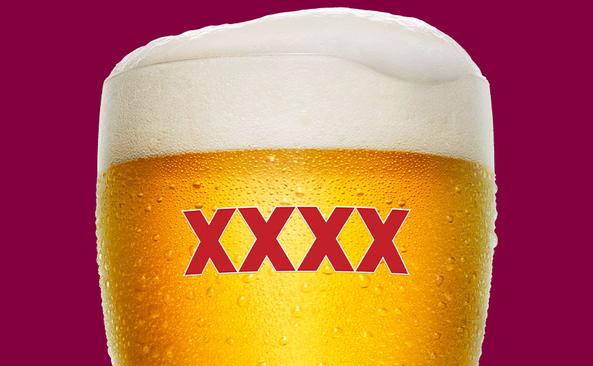 Cropped XXXX-branded glass of beer