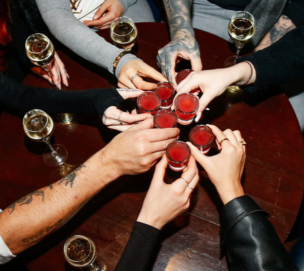 Punters holding shot glasses