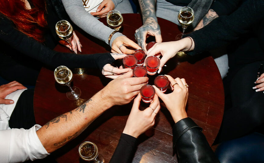 Punters holding shot glasses