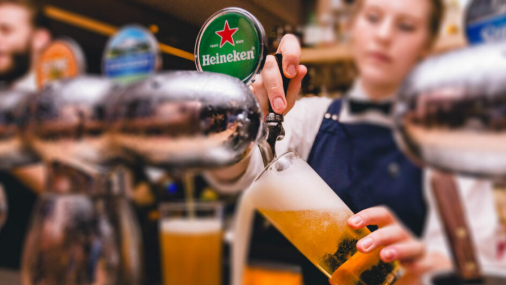 bartender pouring Heineken
