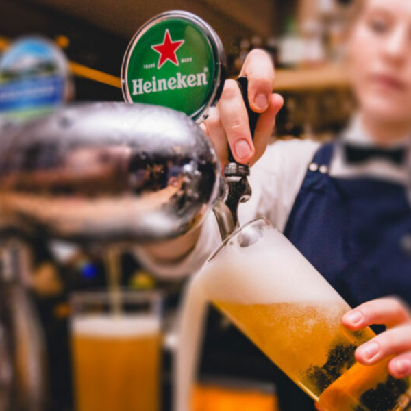 bartender pouring Heineken